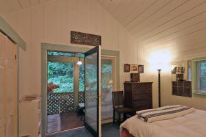 a bedroom with a bed and a door to a balcony at Berkshire Retreat- A stone's throw to downtown Lenox in Stockbridge