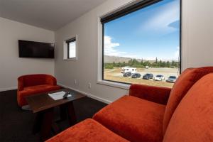 a waiting room with two chairs and a window at Tekapo Lakefront Apartments in Lake Tekapo