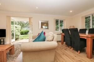 a living room with a couch and a dining room table at Bramble Cottage in Falmouth