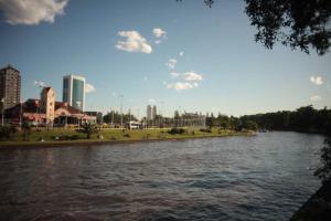 a view of a river with a city in the background at Departamento Tarquinio en Tigre, Buenos Aires in Tigre