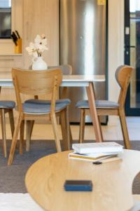 a table with two chairs and a table with books on it at Large trendy 3 Bedroom Residence, Central City in Christchurch