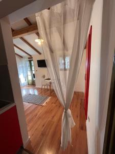 a curtain in a living room with a table at Gaya apartments in Šibenik