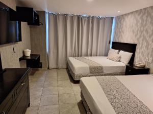 Postel nebo postele na pokoji v ubytování Hotel Costa Verde