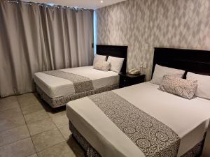Postel nebo postele na pokoji v ubytování Hotel Costa Verde