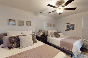 a bedroom with two beds and a ceiling fan at Lake Fork Fort in Emory