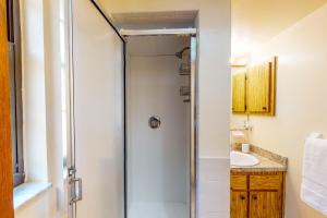 a bathroom with a shower and a sink at Little Hawk Villa in Crystal River +21 photos