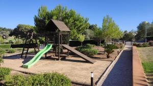 a playground with a slide in a park at Palm House Alvor in Alvor