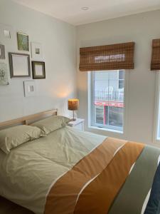 a bedroom with a large bed with a window at Yin et Yang in Sainte-Anne-de-Beaupré