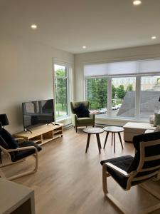 a living room with a couch and a tv at Yin et Yang in Sainte-Anne-de-Beaupré