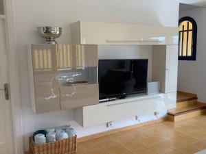 a living room with a flat screen tv on a wall at Villa Bahia Meloneras in Meloneras