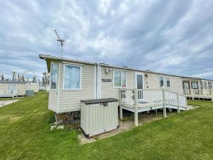 a mobile home with a porch and a yard at Modern 6 Berth Caravan For Hire At Fantasy Island In Skegness Ref 58009d in Skegness