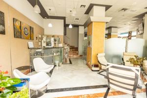 a lobby of a store with white chairs at Hotel Montedobra in Torrelavega