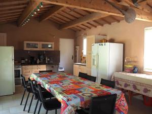 a kitchen with a table with chairs and a refrigerator at Premium villa with garden and private pool, Lambesc in Lambesc