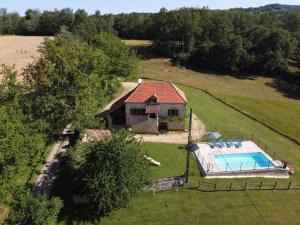 an aerial view of a house with a swimming pool at Lovely holiday home in stunning location private pool and 6 mountain bikes in Théminettes