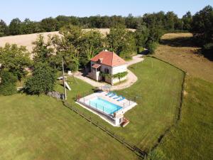 an aerial view of a house with a swimming pool at Lovely holiday home in stunning location private pool and 6 mountain bikes in Théminettes
