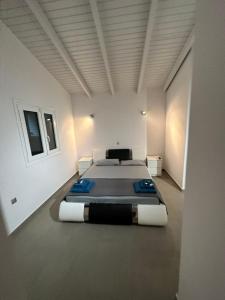 a large white room with two beds in it at Ocean Waves - Alykes Beach in Drosia
