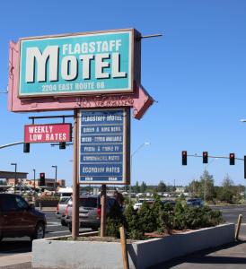 a sign for a fast food motel in a parking lot at Flagstaff Motel in Flagstaff