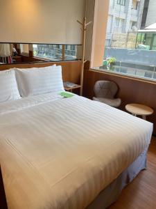 Postel nebo postele na pokoji v ubytování 盤古捷旅 - Panco Hotel