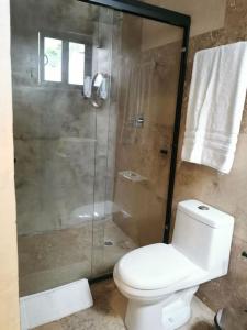 a bathroom with a toilet and a glass shower at MaaR Estudios 6, a 2 cuadras del Malecón de La Paz in La Paz