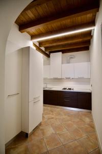 een keuken met witte kasten en een tegelvloer bij Dolce Vita Apartment - Salò in Salò