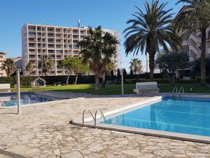 ein Schwimmbad vor einem großen Gebäude in der Unterkunft Apartaments Marítim Torre Valentina in Sant Antoni de Calonge
