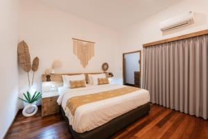 a bedroom with a large bed in a room at Secret Haven Cozy 3 Bedroom Private Pool Villa in Gili Trawangan