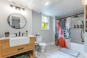 a bathroom with a sink and a toilet and a mirror at Unique Stay! Ricketts Chic Farmhouse Retreat with Stargazing Bubble Tent 