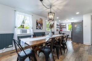 a dining room with a wooden table and chairs at Unique Stay! Ricketts Chic Farmhouse Retreat with Stargazing Bubble Tent in Stillwater