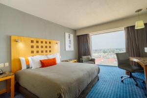 Postel nebo postele na pokoji v ubytování Real Inn Ciudad Juarez by the USA Consulate