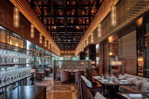 a restaurant with tables and chairs and wine glasses at The Ritz-Carlton, Langkawi in Pantai Kok