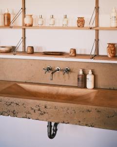 a bathroom with a sink on a wooden shelf at guesthouse by good neighbor in Baltimore