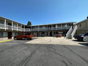 a truck parked in a parking lot in front of a building at Royal Victorian Motel in Port Angeles