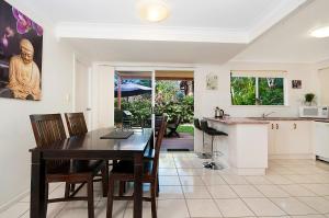 a kitchen and dining room with a table and chairs at Shivas@Byron... minutes walk to Main Beach! in Byron Bay
