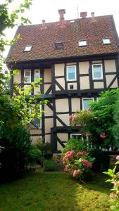 een zwart-wit gebouw met een rood dak bij Ackerbürgerhaus von 1604 in Goslar