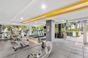 an indoor gym with cardio equipment in a house at Modern Riverside Oasis - Gym Pool WiFi & Parking in Brisbane