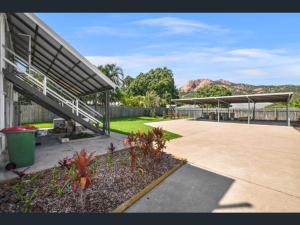 a building with a parking lot with a patio at Townsville Suites in Townsville