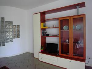 a living room with a cabinet with a tv in it at La Zucca a Pois in Formia