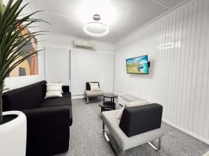 a living room with a couch and two chairs at Gladstone Gem 6 - Suva CBD 2bdrm Apts in Suva