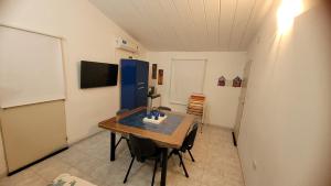 a dining room with a table and a blue refrigerator at Casa Carlos Paz a los pies de la montaña in Villa Carlos Paz