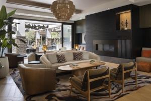 Napa Valley Marriott Hotel & Spa في نابا: غرفة معيشة مع أريكة وطاولة وكراسي