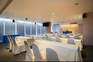 a conference room with white tables and chairs at Veronica Residence in Bangkok