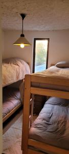 a bedroom with two bunk beds and a window at Ski in-out Apartment in El Colorado in El Colorado