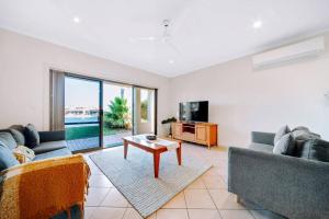 a living room with two couches and a tv at Waterfront Townhouse - One in Port Lincoln