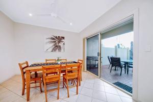 a dining room with a table and chairs at Waterfront Townhouse - One in Port Lincoln