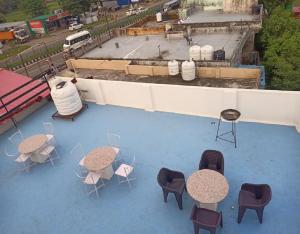 an overhead view of tables and chairs on a roof at Hide and Seek by StayApart in Dehradun