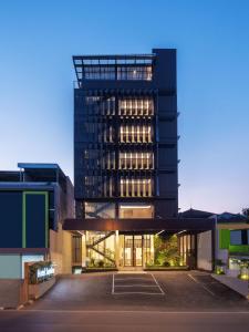 a building with a parking lot in front of it at Hotel Santika PasirKaliki in Bandung