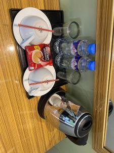 a bunch of plates and bottles in a refrigerator at Sun Star Grand Hotel in Manila