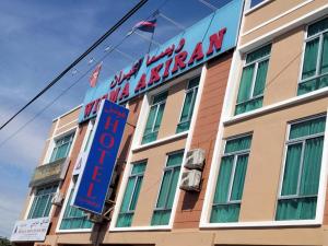 a building with a sign for a hotel at Alia Express Dey Hotel Kota Bharu in Kota Bharu