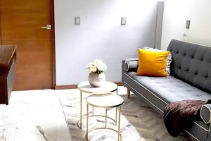 a living room with a couch and a table with a yellow pillow at Orozco MaiaHome-POLANCO 1BR close to Antara in Mexico City