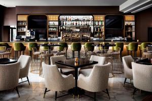 a bar with chairs and tables in a restaurant at The Gwen, a Luxury Collection Hotel, Michigan Avenue Chicago in Chicago